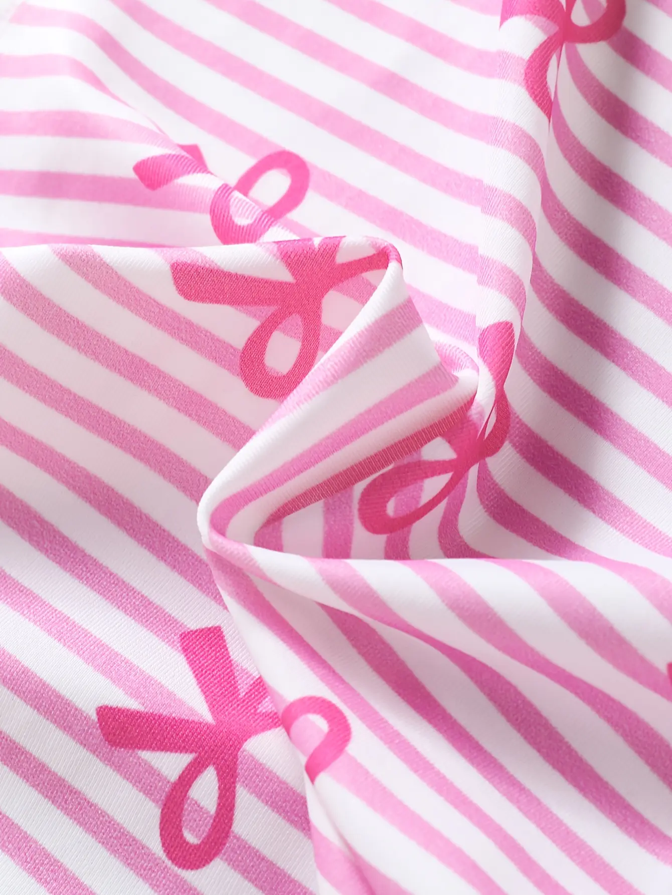 Detail view of Girls Pink Bow Stripe One-Piece Swimsuit with Skirt by LUNORIANA