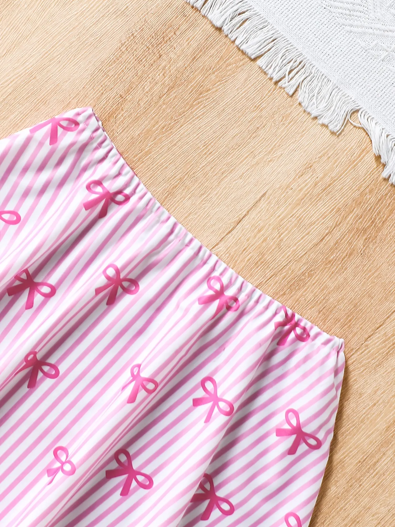 Detail view of Girls Pink Bow Stripe One-Piece Swimsuit with Skirt by LUNORIANA