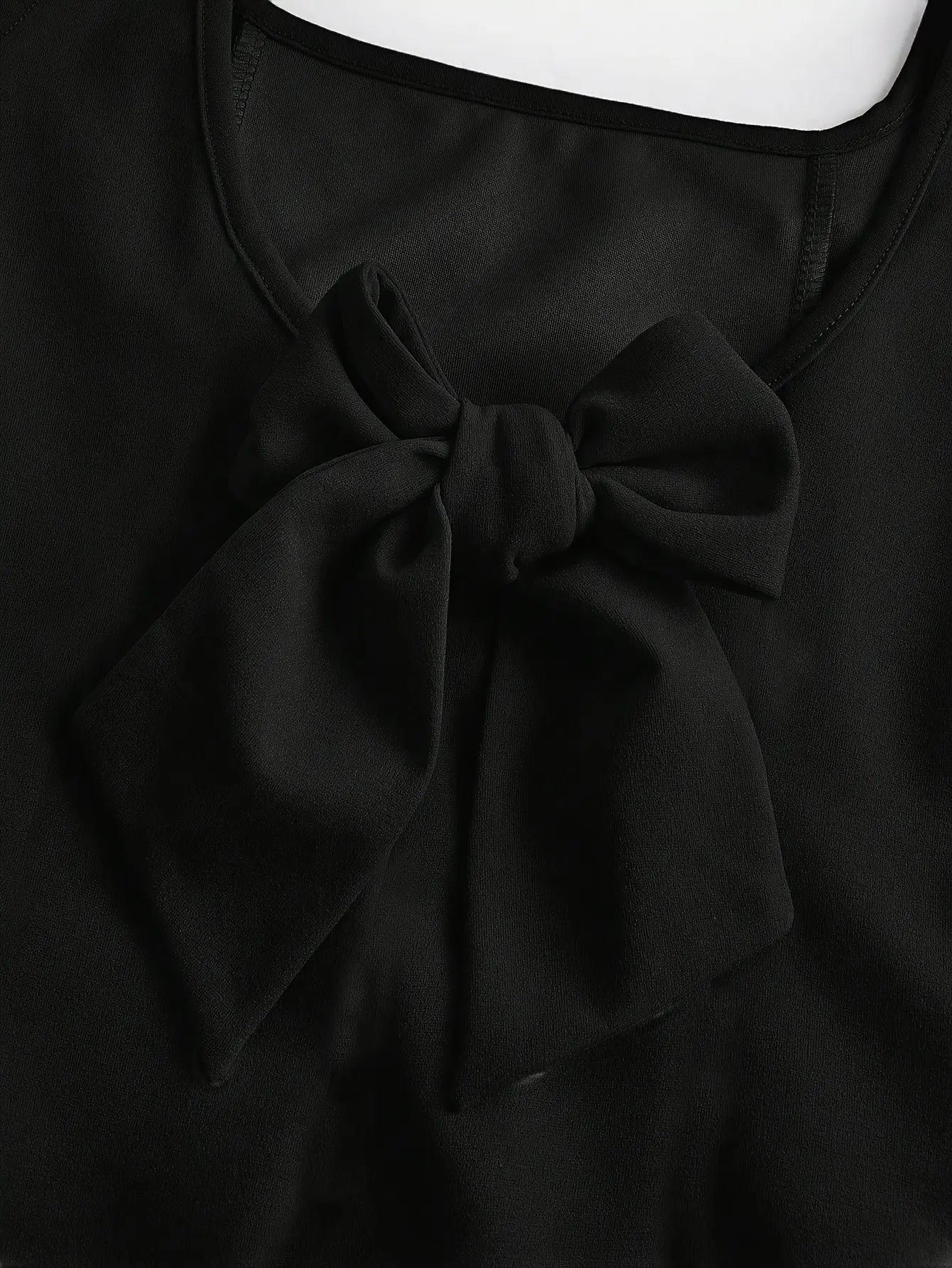 Detail view of Girls Solid Black Long Dress with Back Bow Embroidery by LUNORIANA