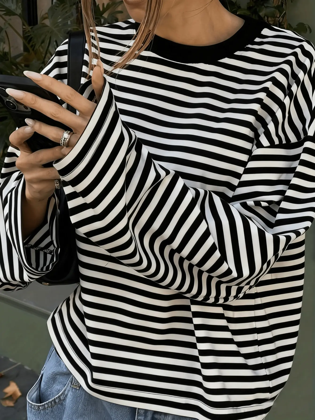 Women’s black striped drop-shoulder T-shirt sleeve detail