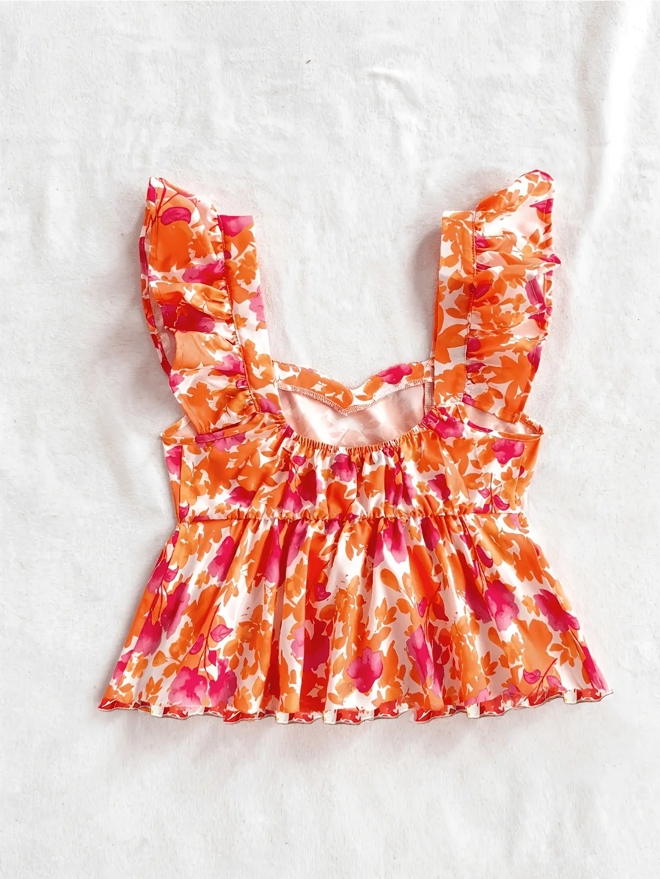 Women’s orange floral wide-strap ruffle top flat lay