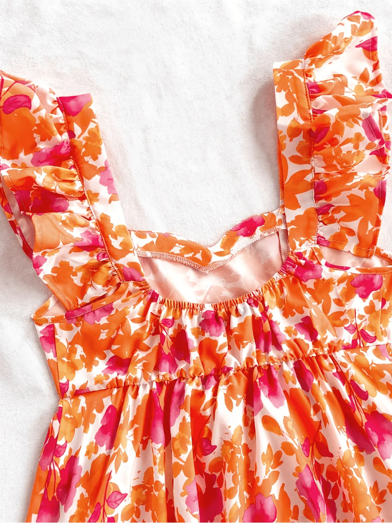 Women’s orange floral wide-strap ruffle top detail