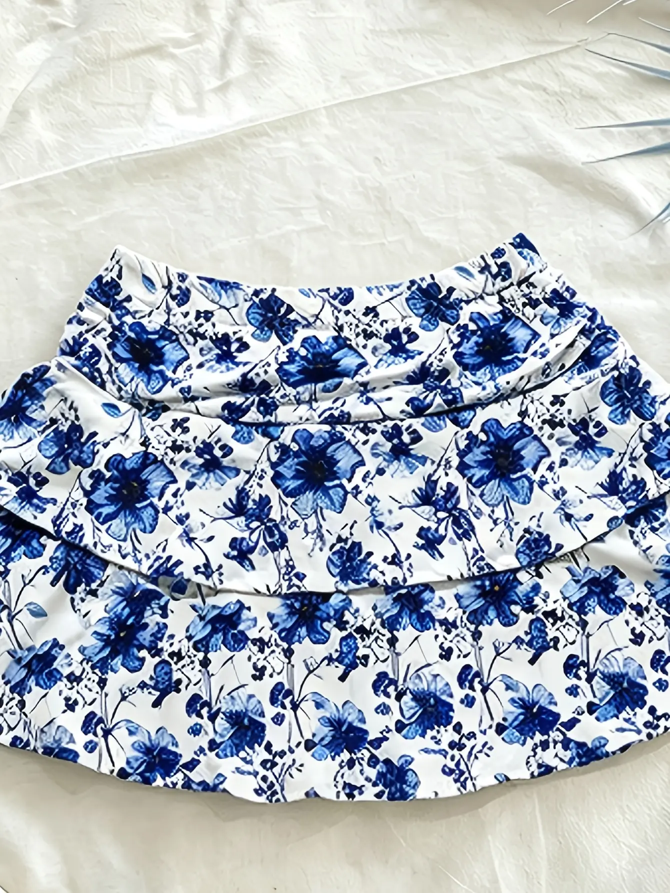Women’s blue floral ruffle-tiered mini skirt close-up