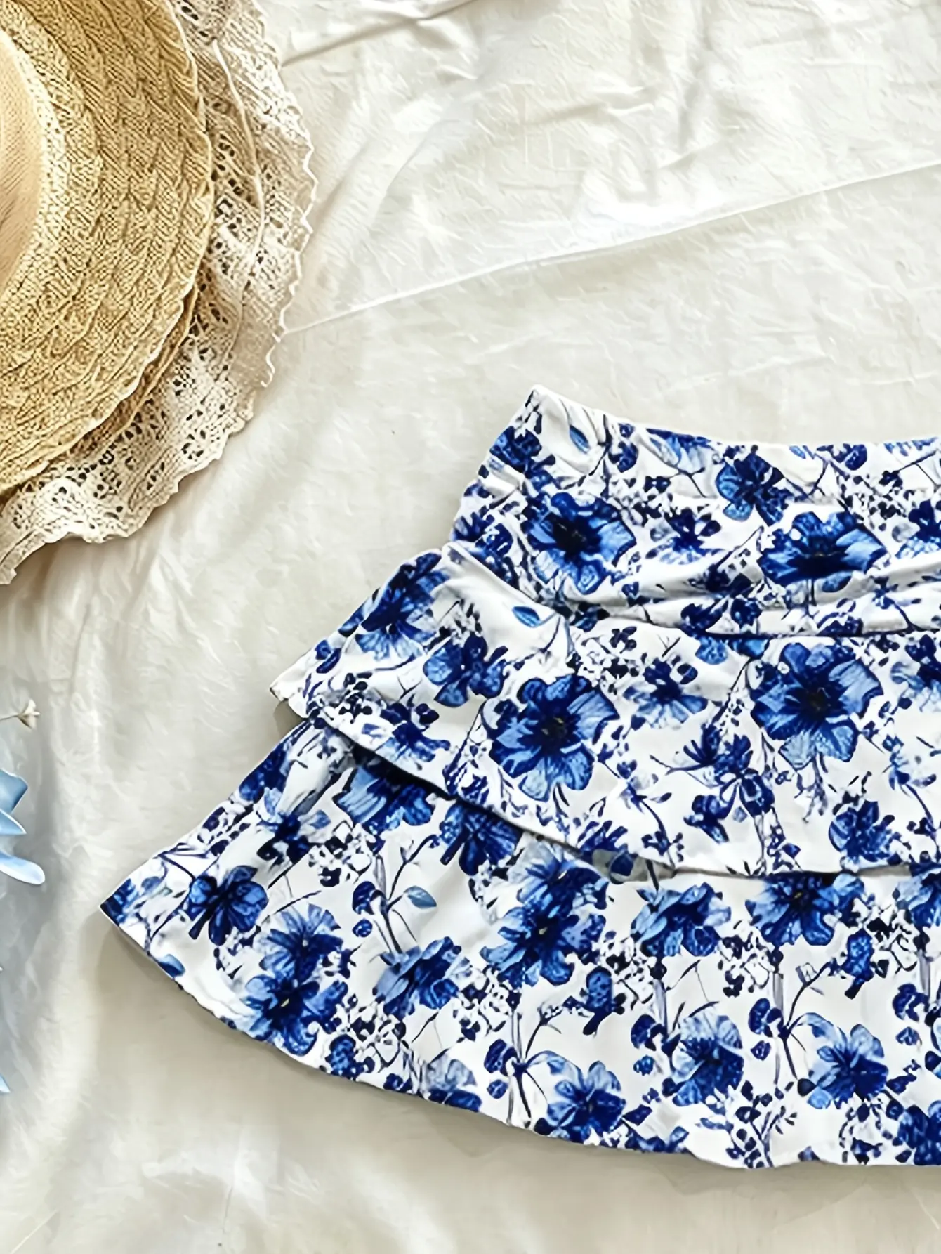 Women’s blue floral ruffle-tiered mini skirt flat lay