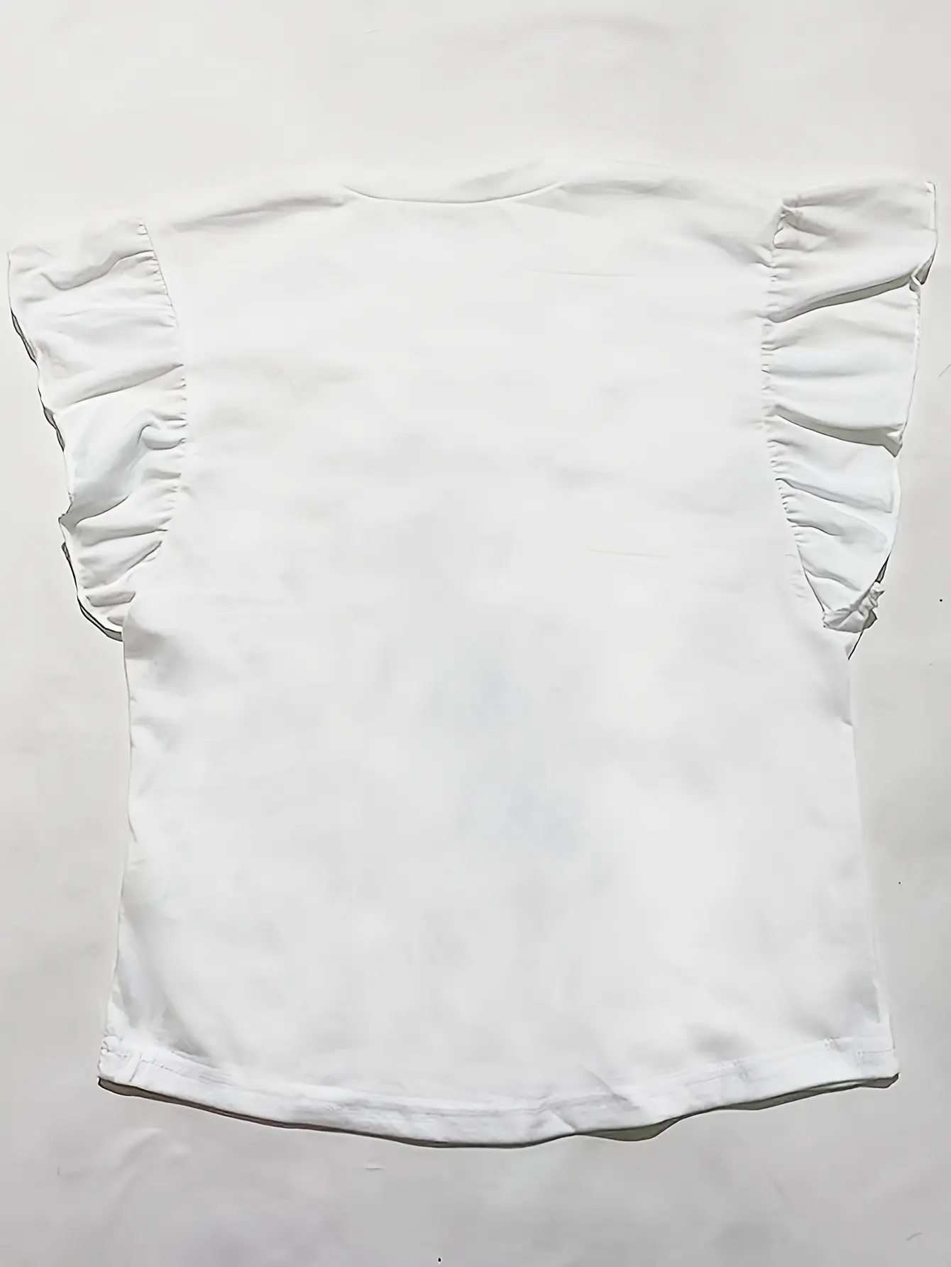 Back view of white ruffle-sleeve top