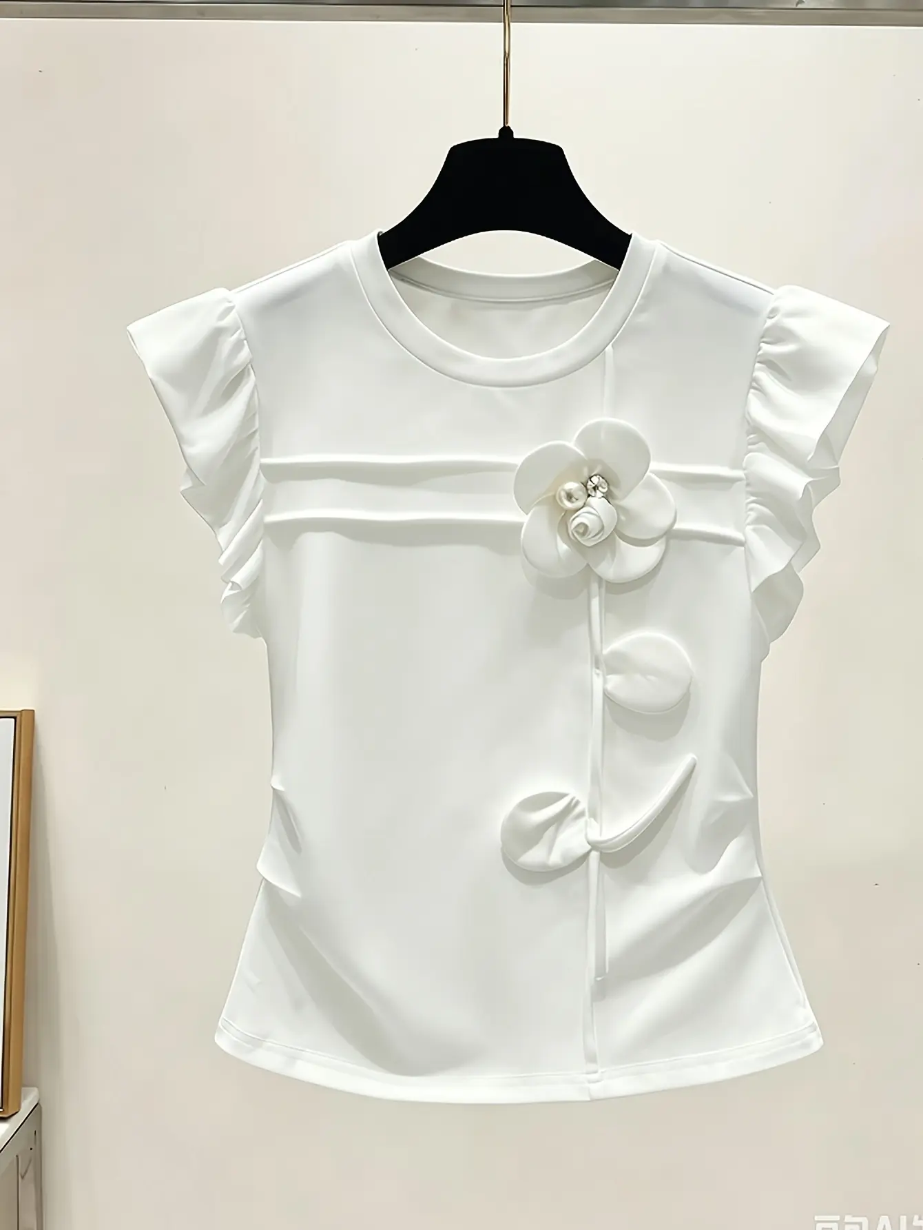 White ruffle-sleeve top with floral applique