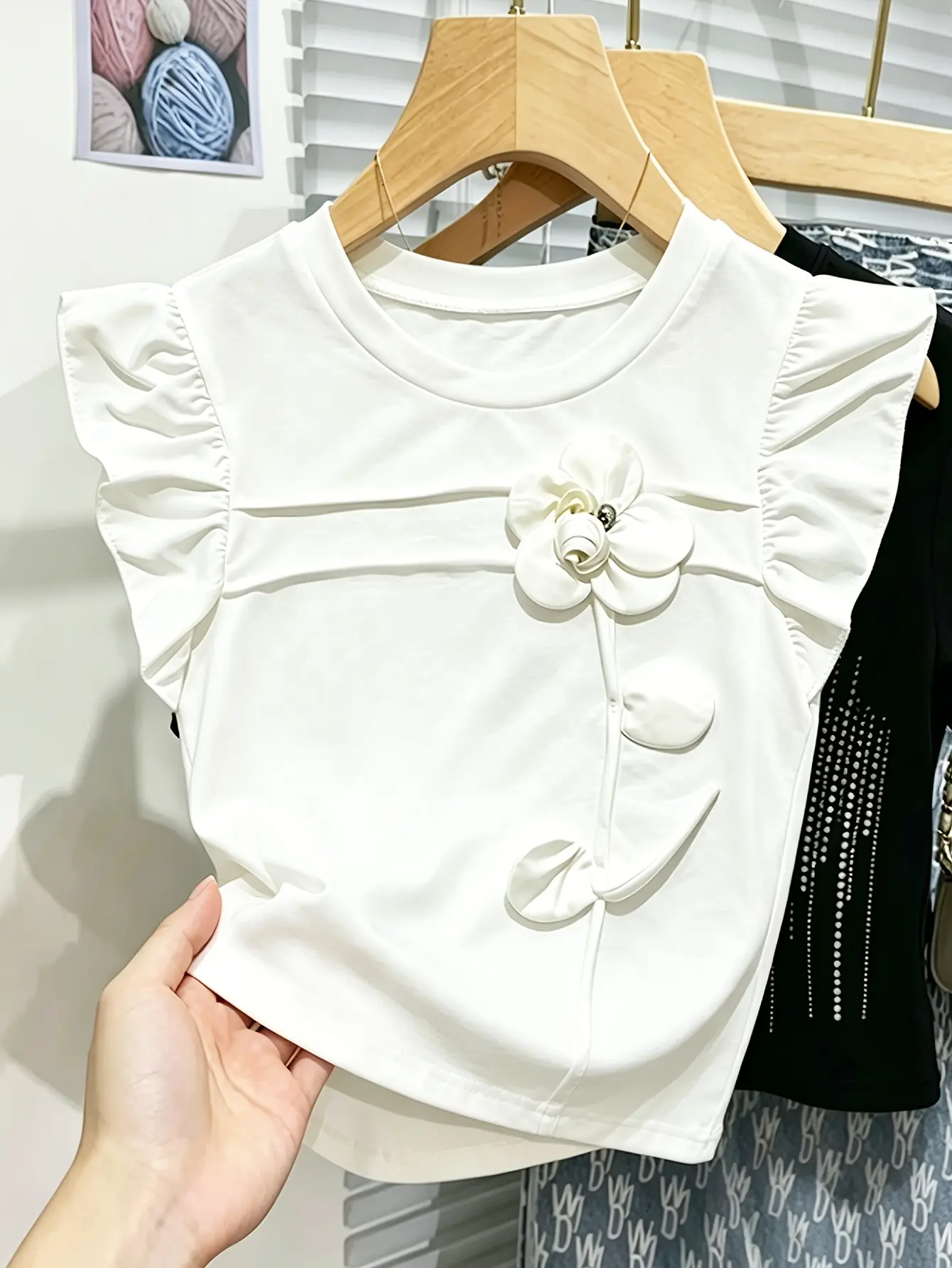 White ruffle-sleeve top with floral applique