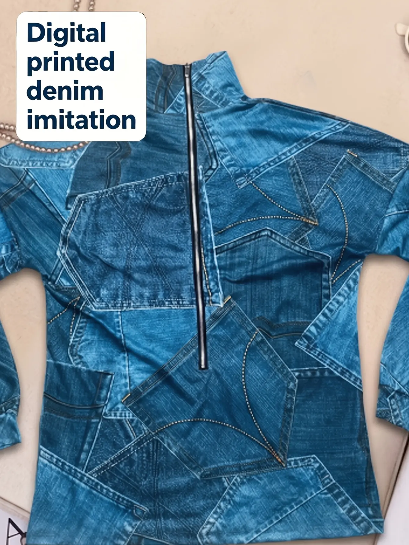 Close-up of blue denim-print top with zip front
