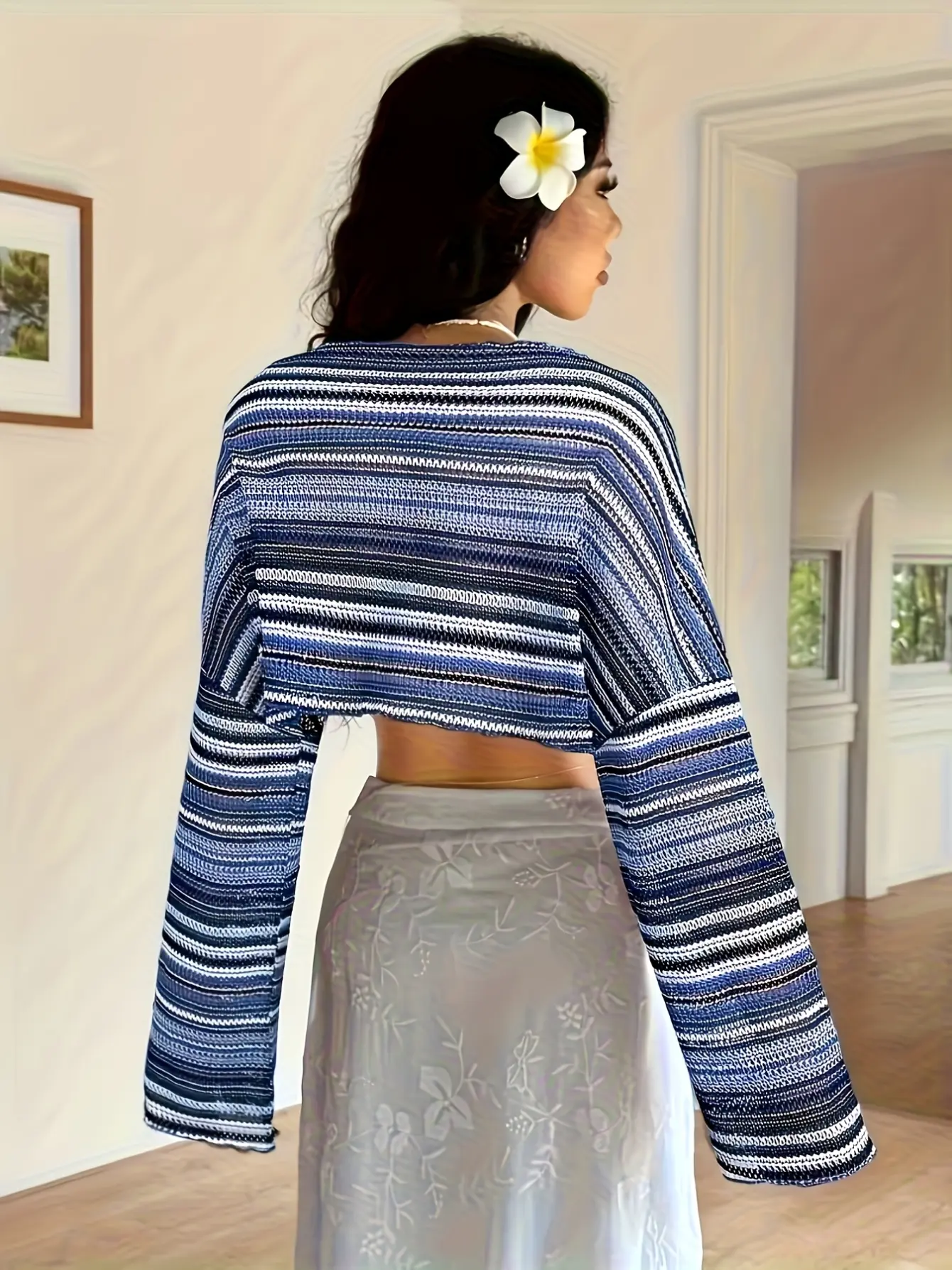 Back view of blue striped crochet-knit bell-sleeve top
